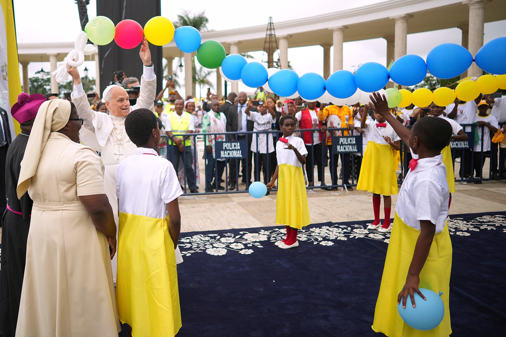 FILE - Before celebrating Mass, Pope Leo XIV Leo joins in with children to help release into the sky balloons tied in the shape of a rosary, at the Basilica of the Immaculate Conception of Mongomo, Equatorial Guinea, April 22, 2026, on the tenth day of his 11-day pastoral visit to Africa. (AP Photo/Andrew Medichini, File)
