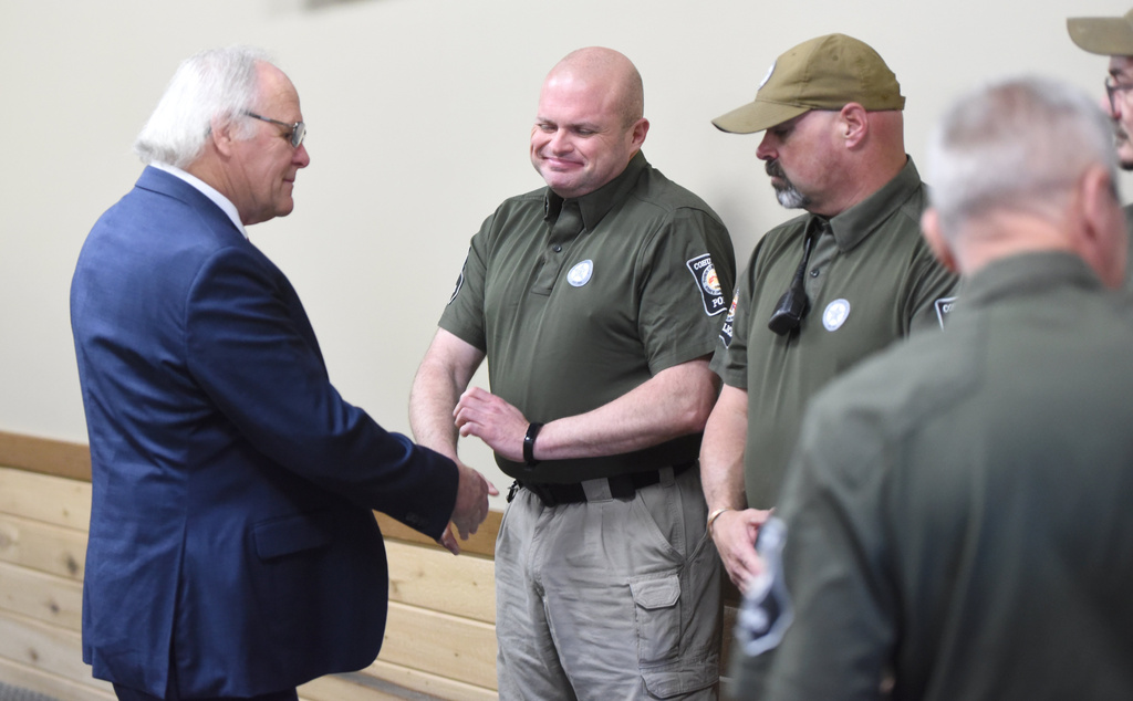 Mayor Ron Shinnick, left, shakes hands with members of the Cohutta Police Department at Cohutta Town Hall in Cohutta, Ga. on Thursday, April 30, 2026. (Matt Hamilton/Chattanooga Times Free Press via AP)