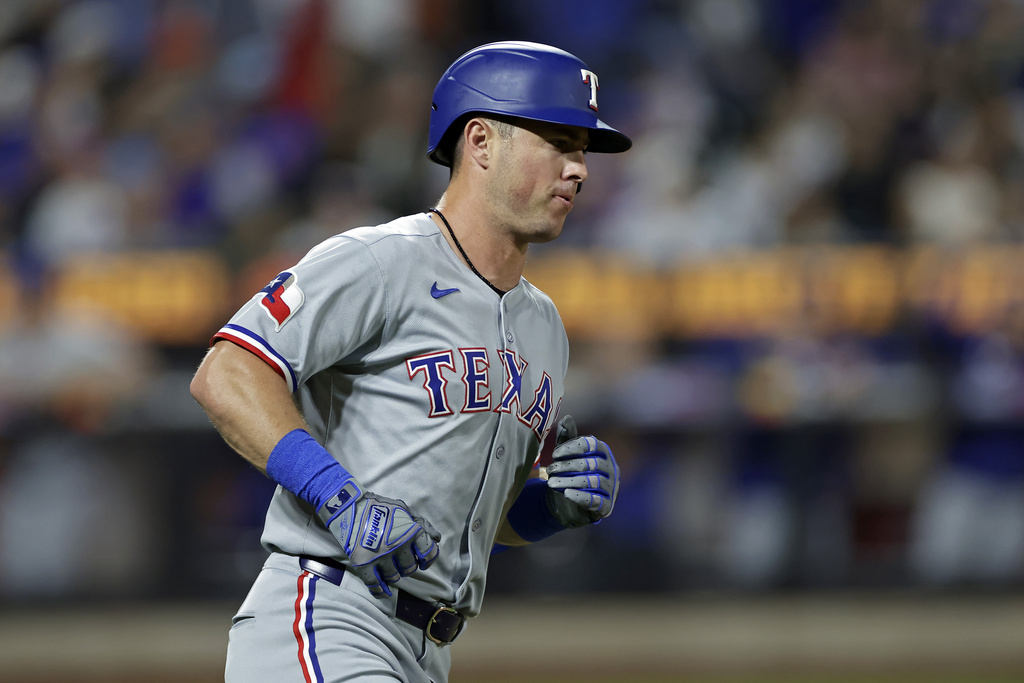 Texas Rangers' Dylan Moore rounds the bases after hitting a 2-run home run during the seventh inning of a baseball game against the New York Mets, Friday, Sept. 12, 2025, in New York. (AP Photo/Adam Hunger)