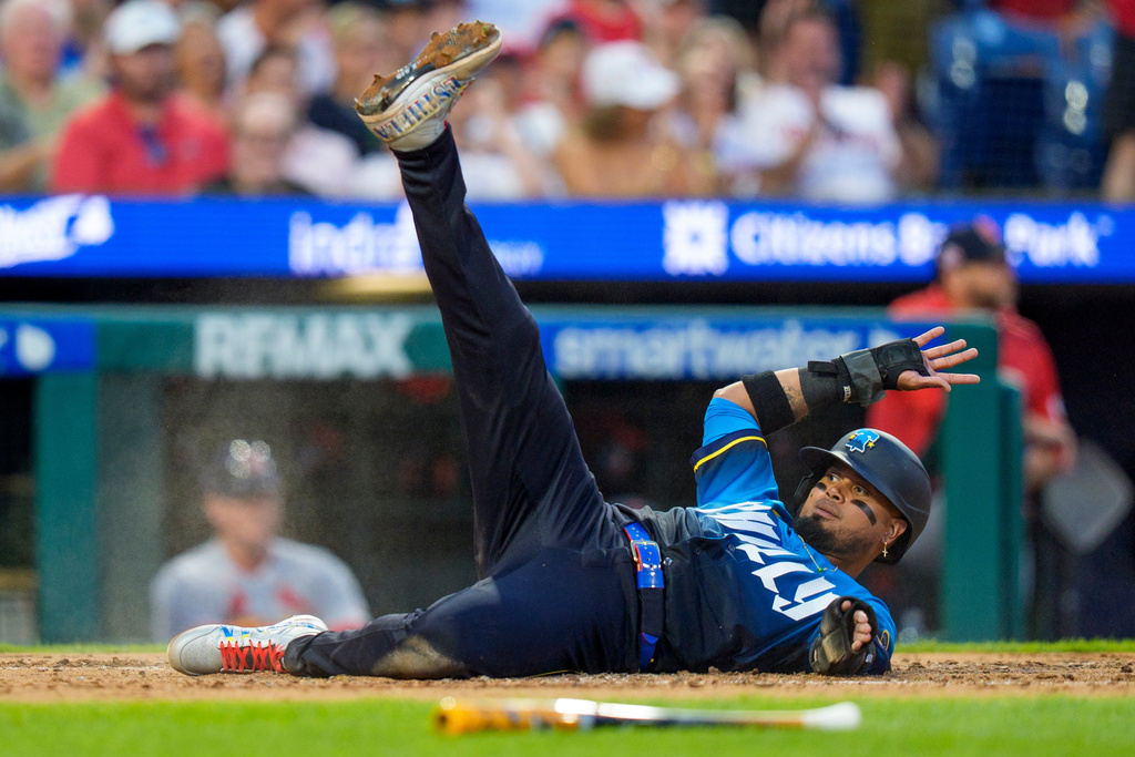 Philadelphia Phillies' Luis Arraez slides into home as he scores on a single hit by Alec Bohm during the third inning of a baseball game against the St. Louis Cardinals, Friday, Aug. 21, 2026, in Philadelphia. (AP Photo/Chris Szagola)
