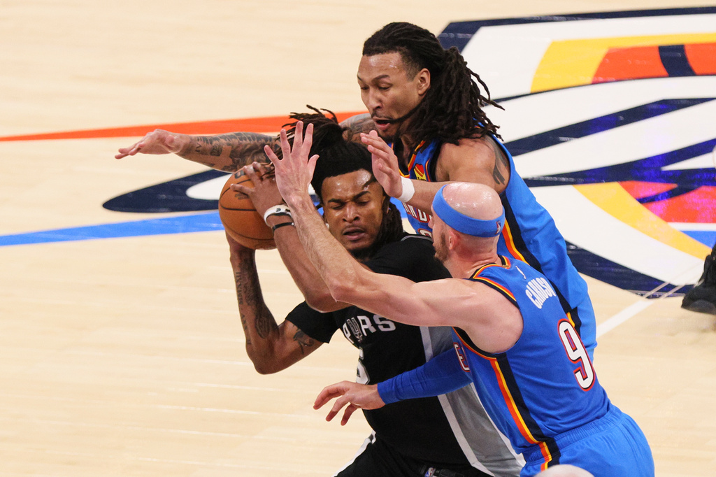 San Antonio Spurs guard Stephon Castle (5) is covered by Oklahoma City Thunder guard Alex Caruso (9) and forward Jaylin Williams in the second half of Game 7 of the Western Conference finals of the NBA basketball playoffs series Saturday, May 30, 2026, in Oklahoma City. (AP Photo/Nate Billings)