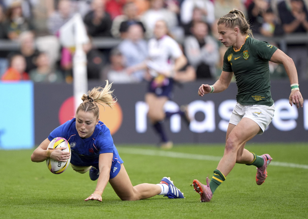 France's Joanna Grisez, left, scores their eighth try during the Women's Rugby World Cup 2025 pool D match between France and South Africa in Northampton, England, Sunday, Sept. 7, 2025. (Joe Giddens/PA via AP)