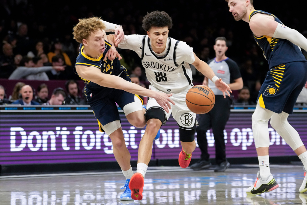 Brooklyn Nets guard Nolan Traore (88) fights for control of the ball with Indiana Pacers guard Taelon Peter during the second half of an NBA basketball game, Wednesday, Feb. 11, 2026, in New York. (AP Photo/Yuki Iwamura)