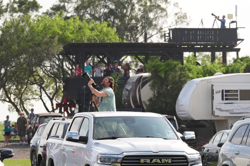 People gather to watch as SpaceX's mega rocket Starship makes a test flight from Starbase, Texas, Friday, May 22, 2026. (AP Photo/Eric Gay)