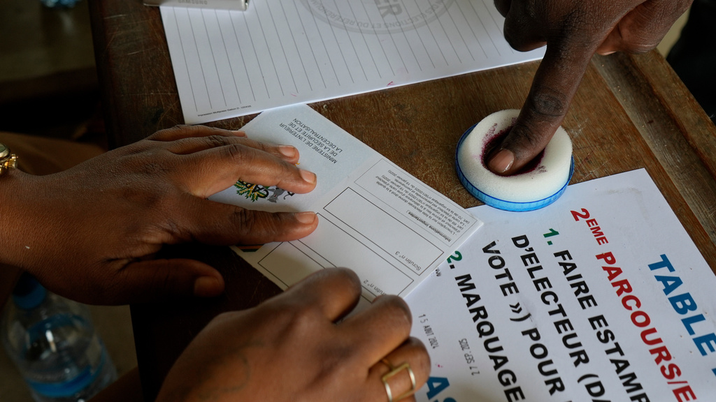 A voter has his finger inked before casting a ballot at a polling station in Libreville, Gabon, Sunday, Sept. 27, 2025. (AP Photo/Betines Makosso)