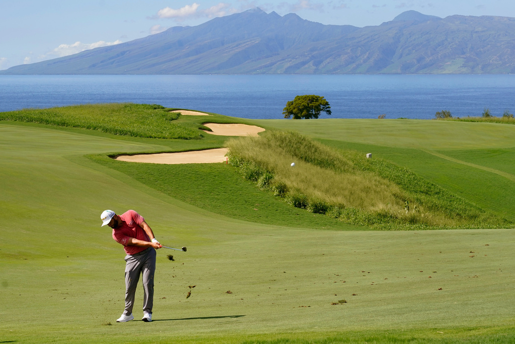 FILE - Jon Rahm, of Spain, hits from the 13th fairway during the final round of the Tournament of Champions golf event, Jan. 9, 2022, at Kapalua Plantation Course in Kapalua, Hawaii. (AP Photo/Matt York, File)