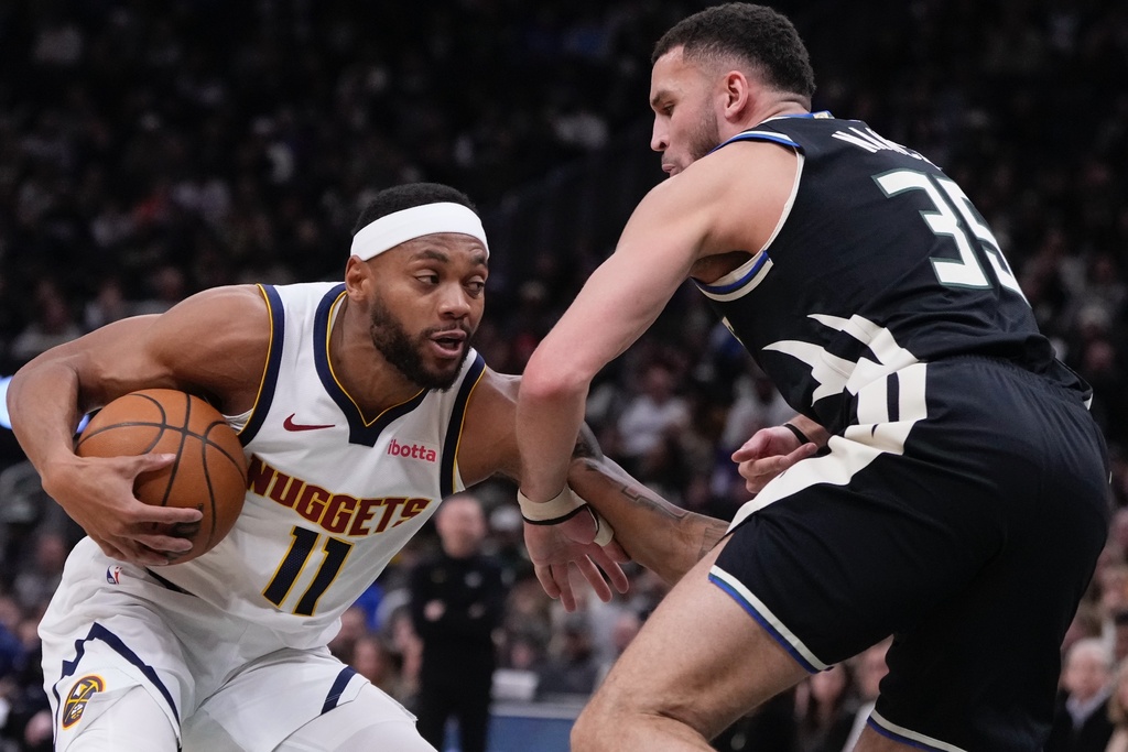 Denver Nuggets' Bruce Brown tries to get past Milwaukee Bucks' Pete Nance during the first half of an NBA basketball game Friday, Jan. 23, 2026, in Milwaukee. (AP Photo/Morry Gash)