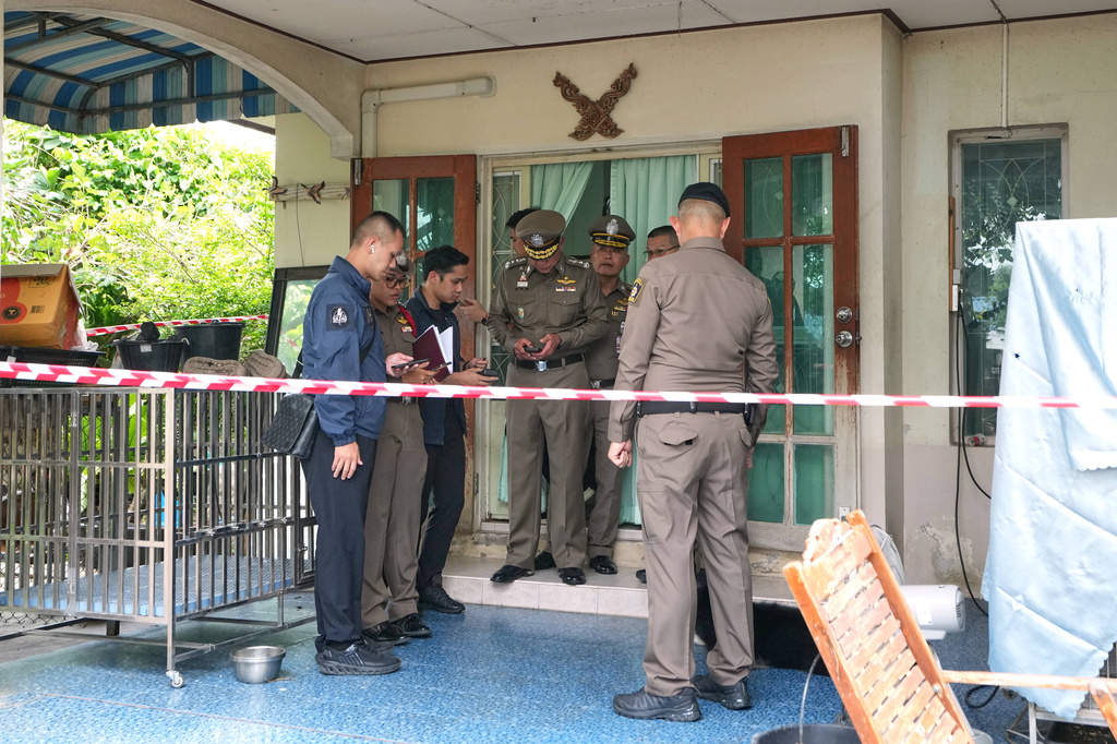 Police stand outside the home a student shot several people Friday at the Debsirin Nonthaburi School in Thailand's Nonthaburi province, Friday, Aug. 7, 2026. (AP Photo/Sakchai Lalit)