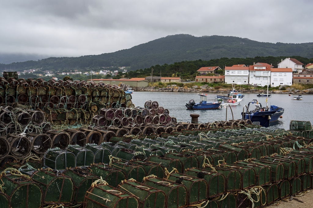 Octopus traps sit on the Port of Lira on Tuesday, June 24, 2025, in Lira, Spain, during an unusually long octopus fishing pause period. (AP Photo/Annika Hammerschlag)