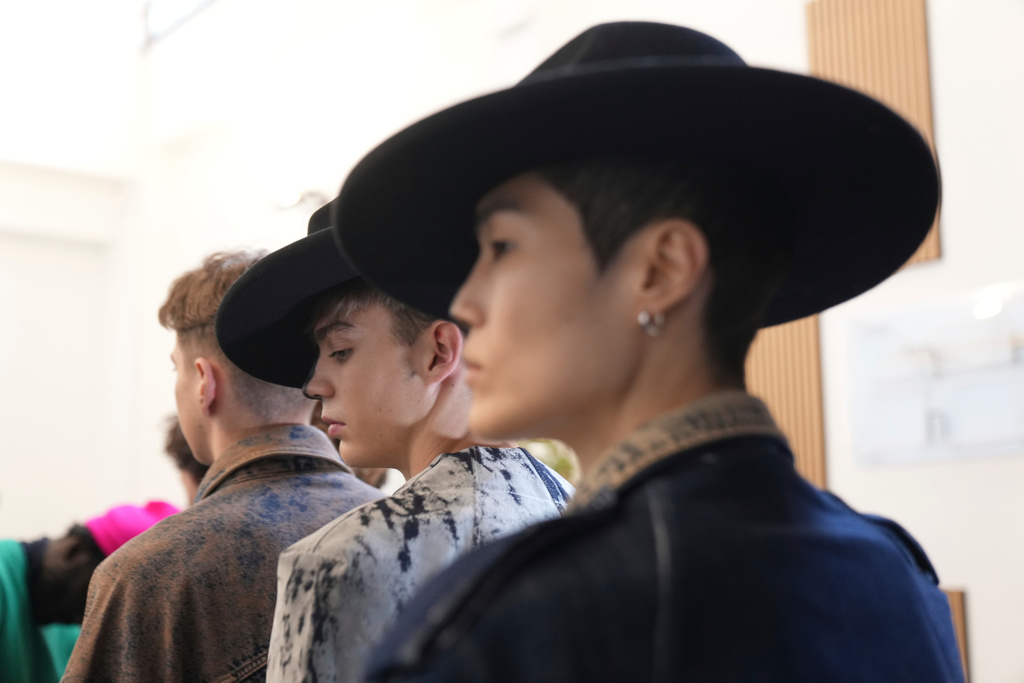 Models get ready in the backstage of the Victor Hart Fall/Winter 2026-2027 Men's fashion show presented in Milan, Italy, Jan. 18, 2026. (AP Photo/Antonio Calanni)