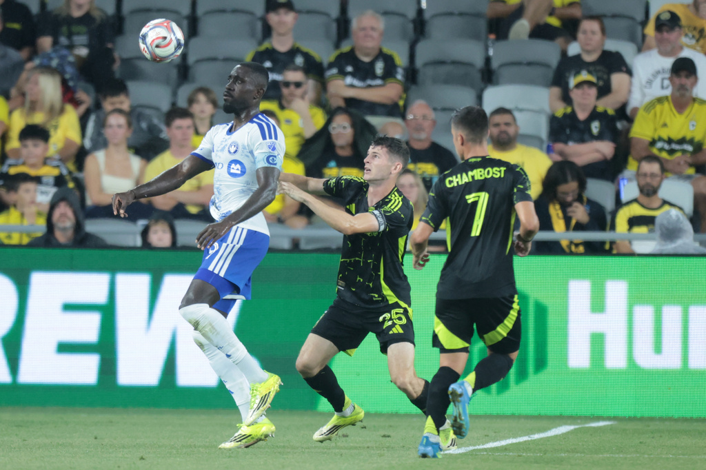CF Montreal forward Prince Owusu, left, works for the ball in front of Columbus Crew midfielder Sean Zawadzki, center, and midfielder Dylan Chambost during the first of an MLS soccer match in Columbus, Ohio, Wednesday, Aug. 19, 2026. (AP Photo/Paul Vernon)