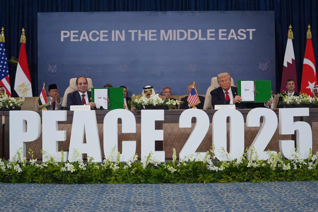 President Donald Trump and Egypt's President Abdel-Fattah el-Sissi hold signed documents during a summit to support ending the more than two-year Israel-Hamas war in Gaza after a breakthrough ceasefire deal, Monday, Oct. 13, 2025, in Sharm El Sheikh, Egypt. (AP Photo/Evan Vucci)