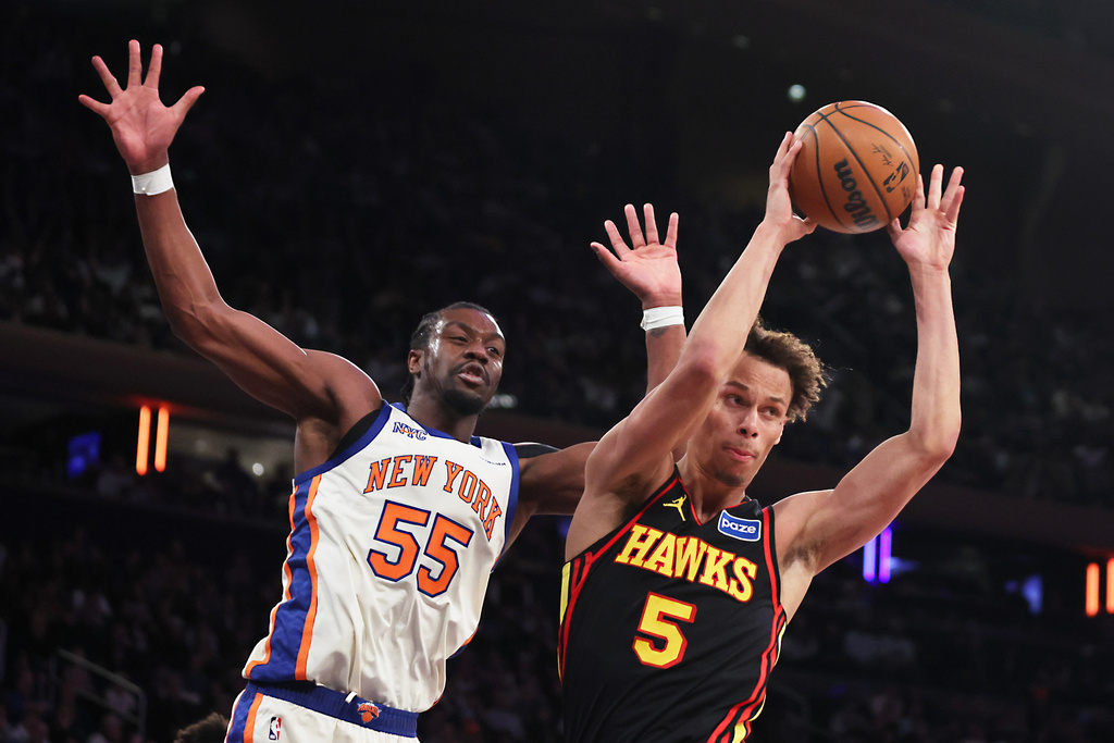 Atlanta Hawks guard Dyson Daniels (5) passes the ball around New York Knicks center Ariel Hukporti (55) during second half of an NBA basketball game, Friday, Jan. 2, 2026, in New York. (AP Photo/Heather Khalifa)