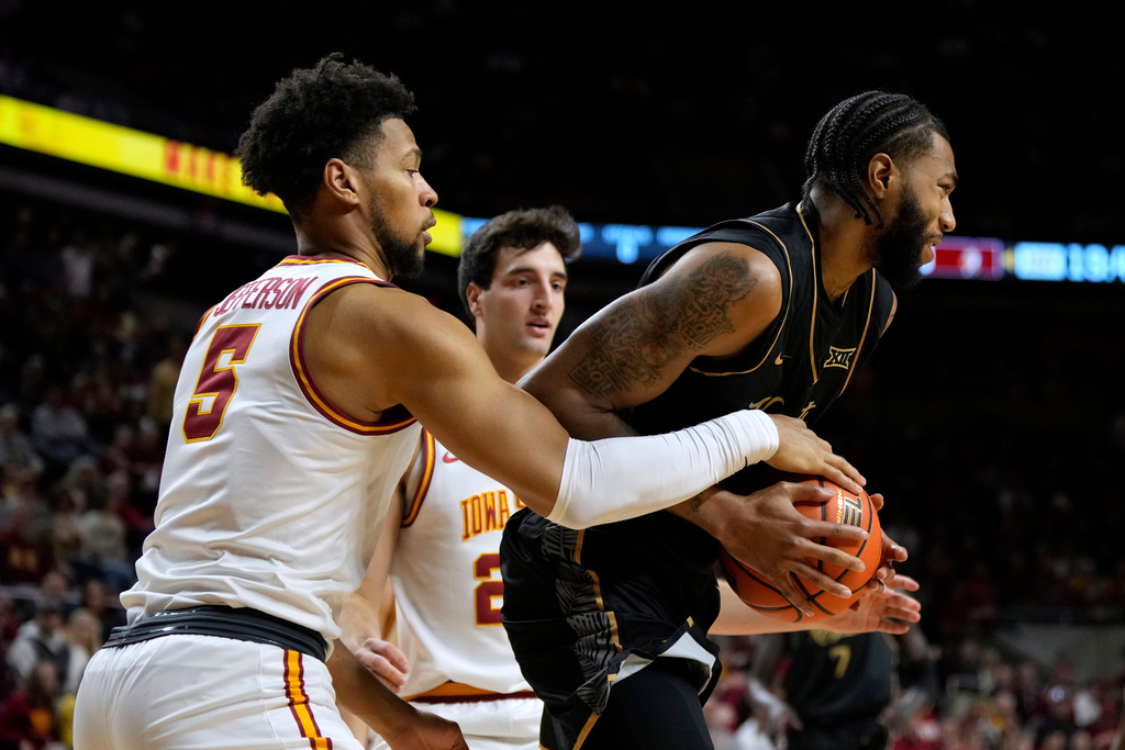 Iowa State forward Joshua Jefferson (5) tries to steal the ball from Central Florida forward Jordan Burks during the first half of an NCAA college basketball game, Tuesday, Jan. 20, 2026, in Ames, Iowa. (AP Photo/Charlie Neibergall)