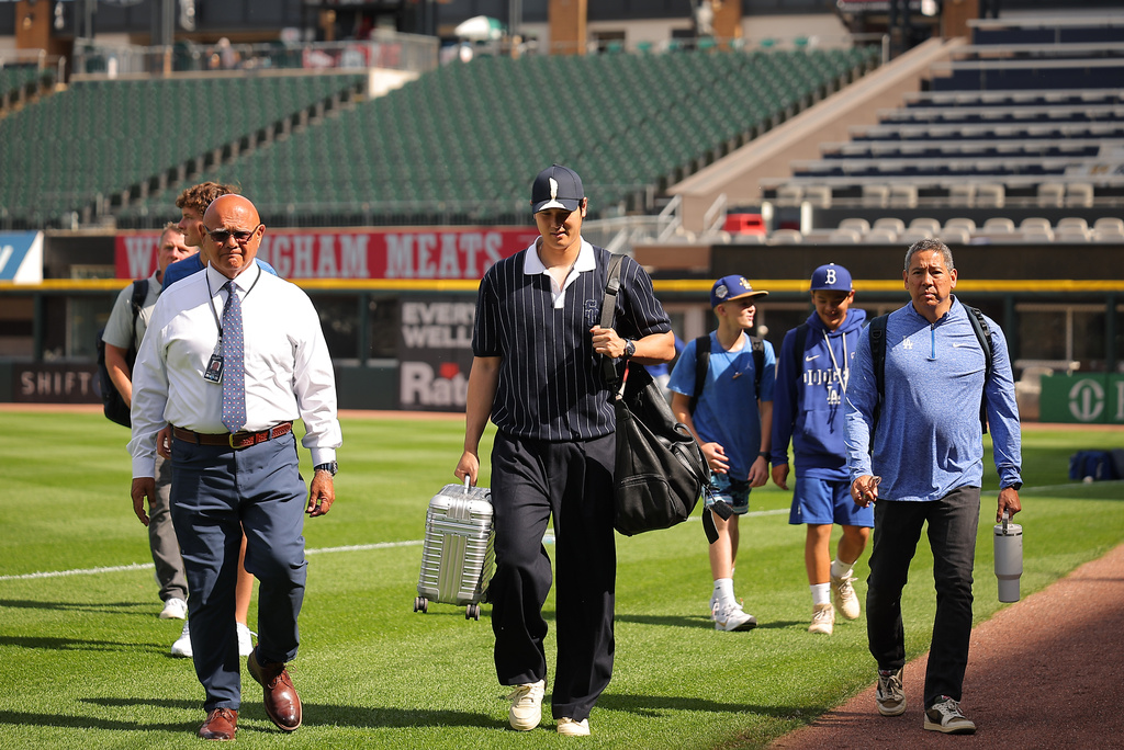 Los Angeles Dodgers' Shohei Ohtani enters the field prior to a baseball game against the Chicago White Sox, Friday, June 12, 2026, in Chicago. (AP Photo/Melissa Tamez)