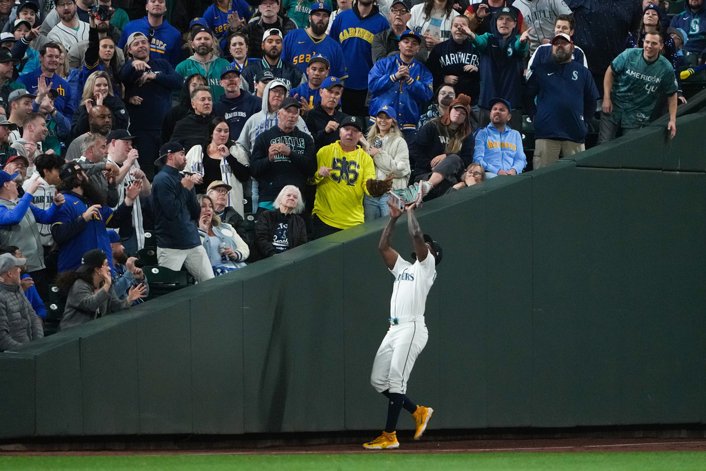 Seattle Mariners left fielder Randy Arozarena catches a fly ball hit by Detroit Tigers' Riley Greene to take it to the bottom of the 15th inning in Game 5 of baseball's American League Division Series Friday, Oct. 10, 2025, in Seattle. (AP Photo/Lindsey Wasson)