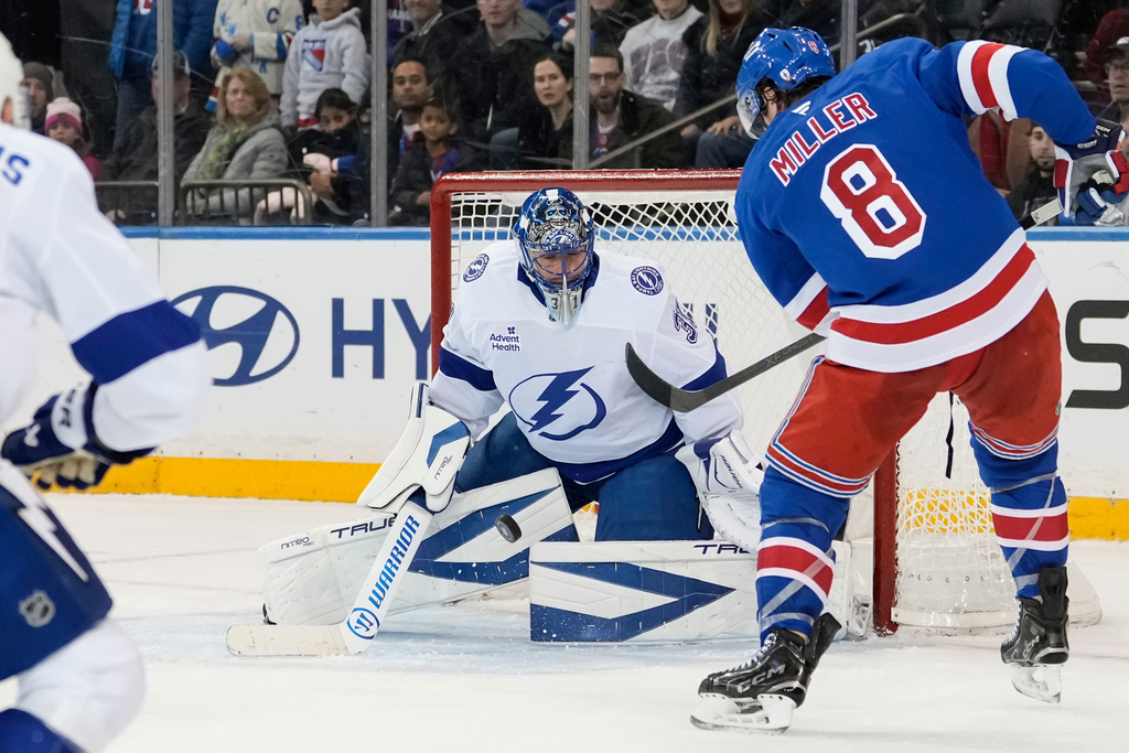 New York Rangers center J.T. Miller (8) shoots the puck during the third period of an NHL hockey game against Tampa Bay Lightning, Saturday, Nov. 29, 2025, in New York. (AP Photo/Yuki Iwamura)