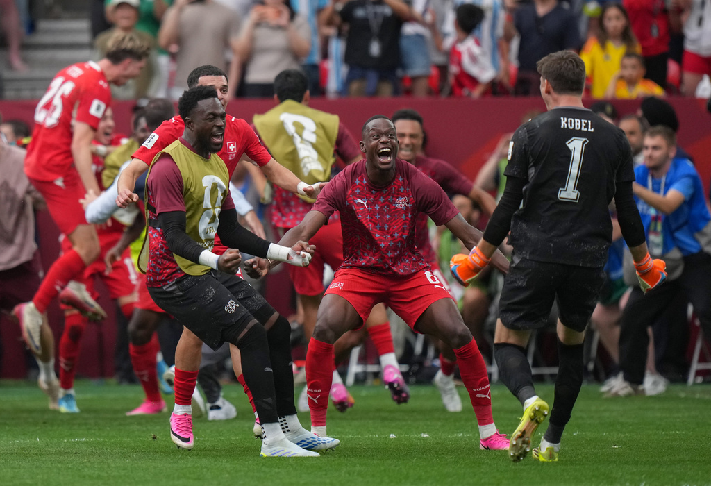 Switzerland's Denis Zakaria, center, goalkeeper Gregor Kobel (1) and their teammates celebrate after winning a penalty shootout in the World Cup round of 16 soccer match between Switzerland and Colombia in Vancouver, British Columbia, Tuesday, July 7, 2026. (Darryl Dyck/The Canadian Press via AP)