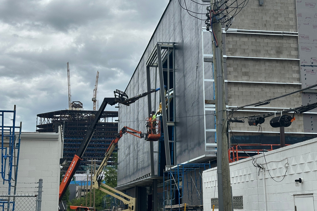 Workers installing glass panes at the Motown Museum expansion in Detroit, June 11, 2026. (AP Photo/Corey Williams)