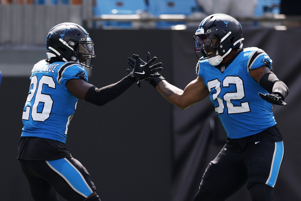 Carolina Panthers cornerback Chau Smith-Wade celebrates after scoring on an interception with linebacker Trevin Wallace against the Atlanta Falcons during the second half of an NFL football game, Sunday, Sept. 21, 2025, in Charlotte, N.C. (AP Photo/Rusty Jones)