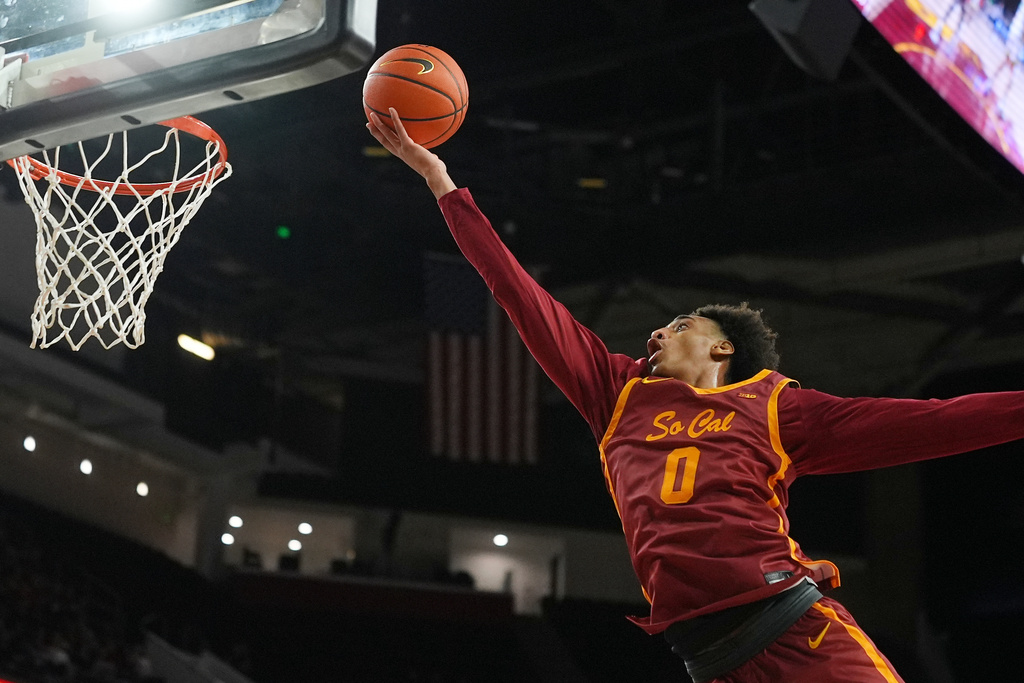 Southern California guard Alijah Arenas (0) scores against Oregon during the second half of an NCAA college basketball game Saturday, Feb. 21, 2026, in Los Angeles. (AP Photo/Damian Dovarganes)