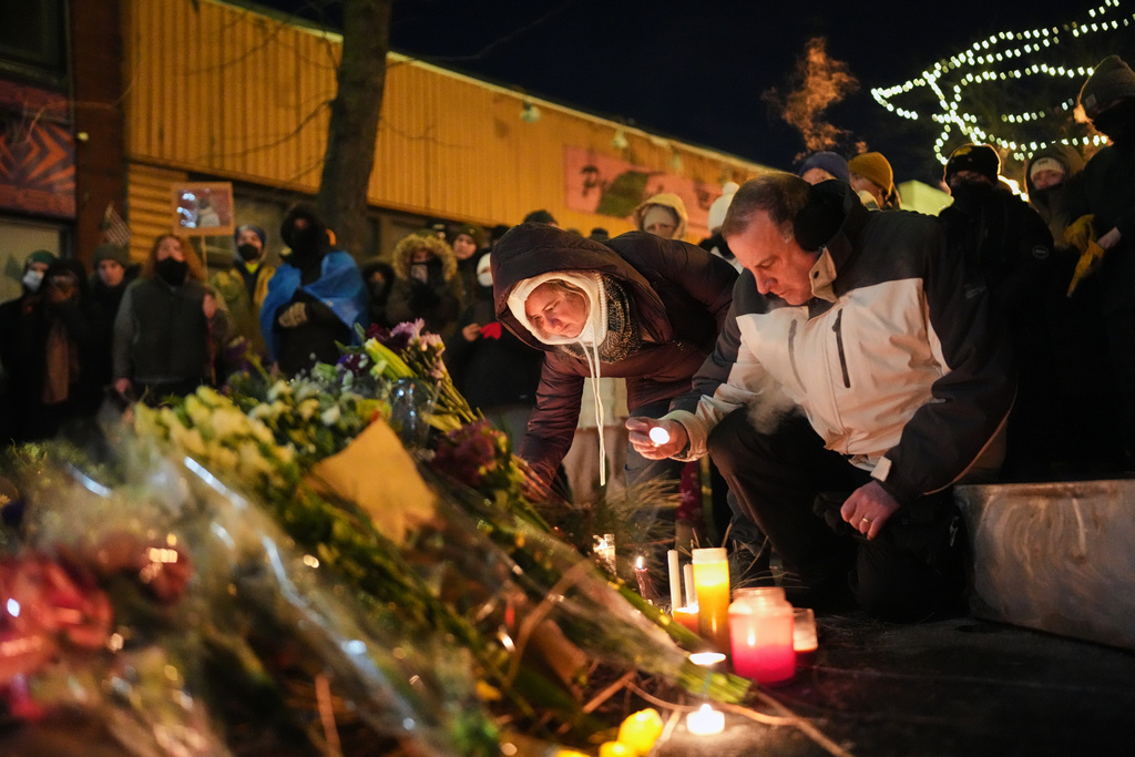 People gather during a vigil for 37-year-old Alex Pretti, who was fatally shot by a U.S. Border Patrol officer earlier in the day, Saturday, Jan. 24, 2026, in Minneapolis. (AP Photo/Adam Gray)