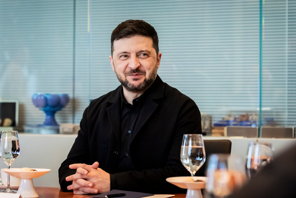 Ukraine's President Volodymyr Zelenskyy smiles during a visit of the German federal parliament, Bundestag, in the Reichstag building in Berlin, Germany, Monday, Dec. 15, 2025. (Christoph Soeder/dpa via AP)