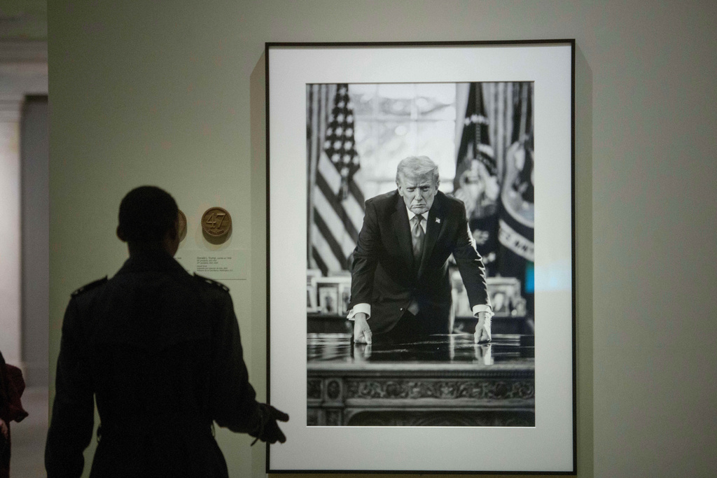 Visitors to the National Portrait Gallery walk past the portrait of President Donald Trump, Sunday, Jan. 11, 2026, in Washington. (AP Photo/Rod Lamkey, Jr.)