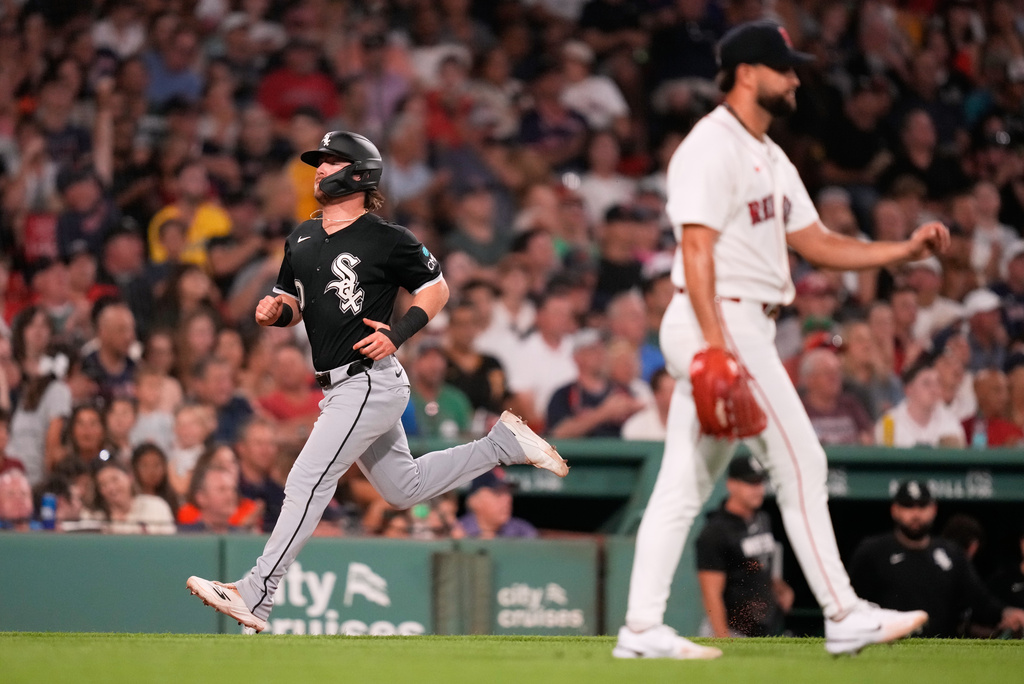 Chicago White Sox's Chase Meidroth, left, scores on a sacrifice by Miguel Vargas during the fifth inning of a baseball game against the Boston Red Sox, Tuesday, Aug. 4, 2026, in Boston. (AP Photo/Charles Krupa)