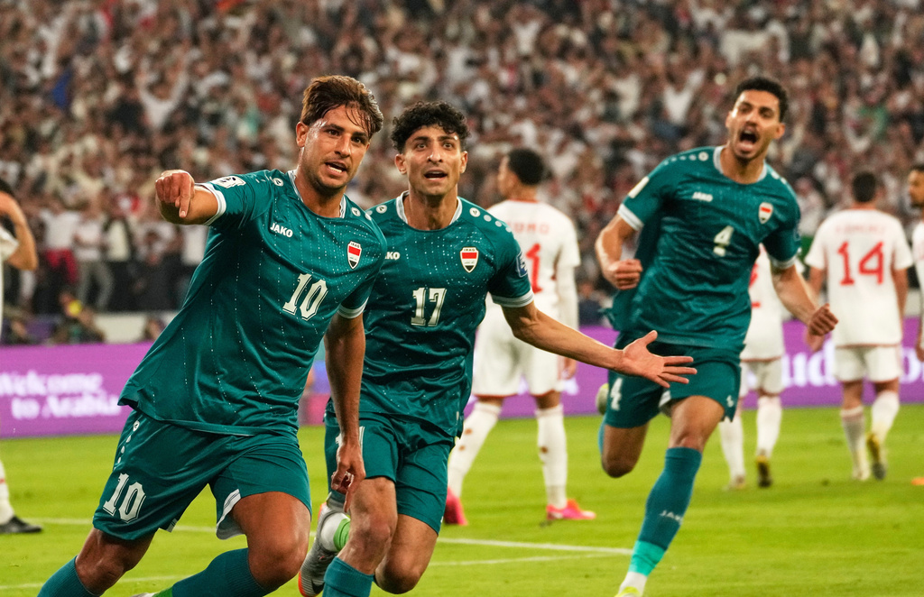 Iraqi's Mohanad Ali, left, celebrates with teammates after scoring his side's first goal during the 2026 World Cup play off second leg match between Iraq and UAE, in Basra, Iraq, Tuesday, Nov. 18, 2025. (AP Photo/Hadi Mizban)