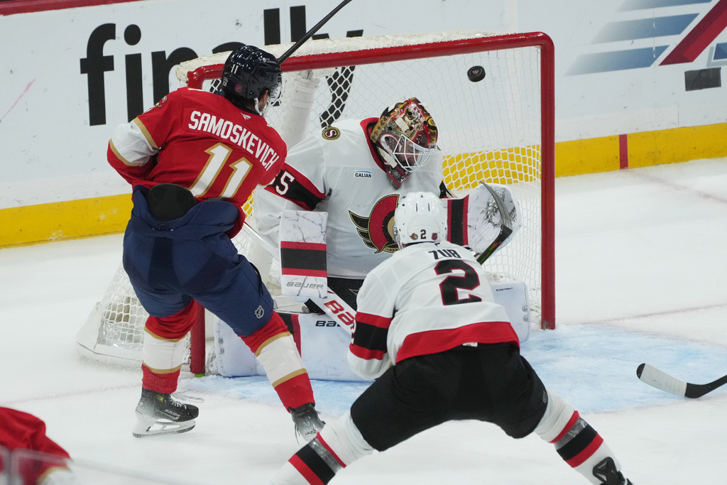 Florida Panthers right wing Mackie Samoskevich (11) scores a goal against Ottawa Senators goaltender Linus Ullmark (35) during the third period of an NHL hockey game, Saturday, Oct. 11, 2025, in Sunrise, Fla. (AP Photo/Marta Lavandier)