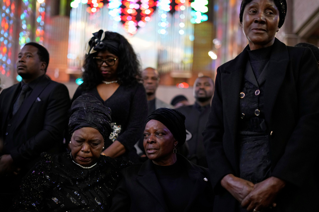FILE -Esther Lungu, widow of Zambia's former President Edgar Lungu, center, and family members attend a Mass at the Cathedral of Christ the King in Johannesburg, South Africa, on June 25, 2025. (AP Photo/Themba Hadebe), File)