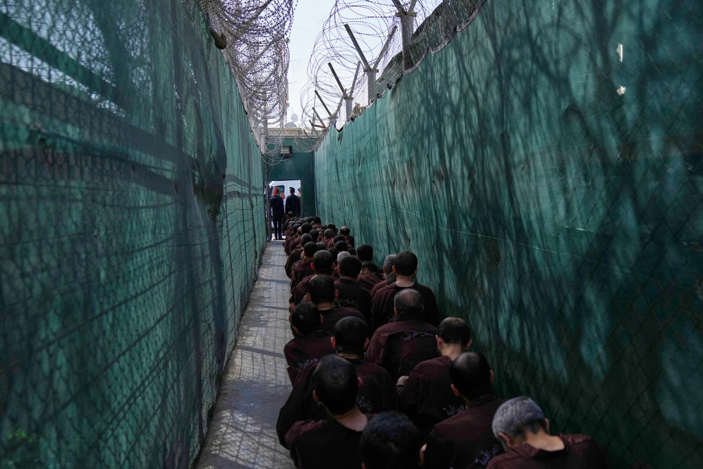 Iraqi security forces lead suspected Islamic State militants for questioning, after they were transferred from Syria to Iraq, at Al-Karkh Central Prison in Baghdad, Iraq, Thursday, Feb. 12, 2026. (AP Photo/Hadi Mizban)