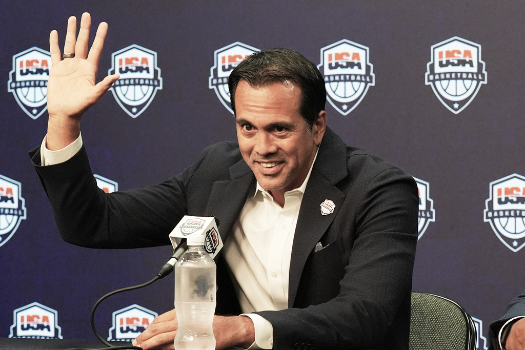 Erik Spoelstra, the head coach of the Miami Heat, raises his hand while explaining how he became USA Basketball men's national team head coach during a news conference Thursday, Oct. 16, 2025, in Miami. (AP Photo/Marta Lavandier)