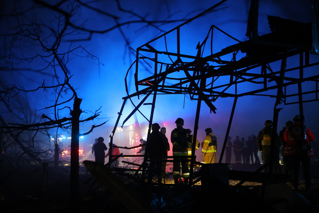 Rescues work at a market destroyed by a Russian airstrike on Zaporizhzhia, Ukraine, Friday, Nov. 21, 2025. (AP Photo/Kateryna Klochko)