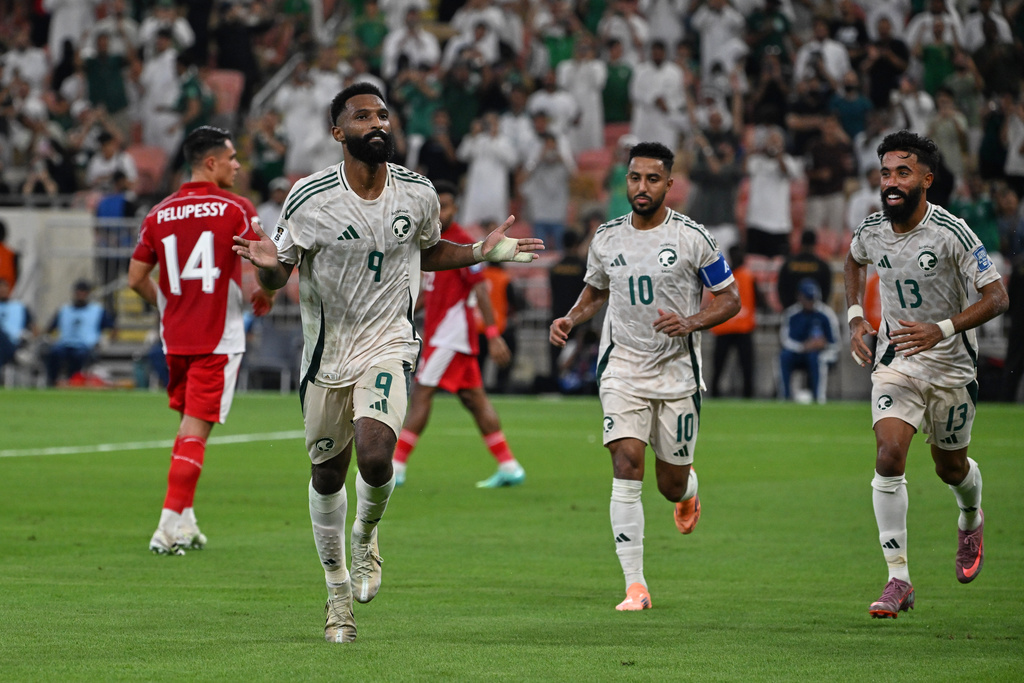 Saudi Arabia's Feras Albrikan, left, celebrates after scoring his side's opening goal during the World Cup 2026 Asian qualifier fourth-round Group B soccer match between Saudi Arabia and Indonesia at Alinma Bank Stadium in King Abdullah Sports City, in Jiddah, Saudi Arabia, Wednesday, Oct. 8, 2025. (AP Photo)