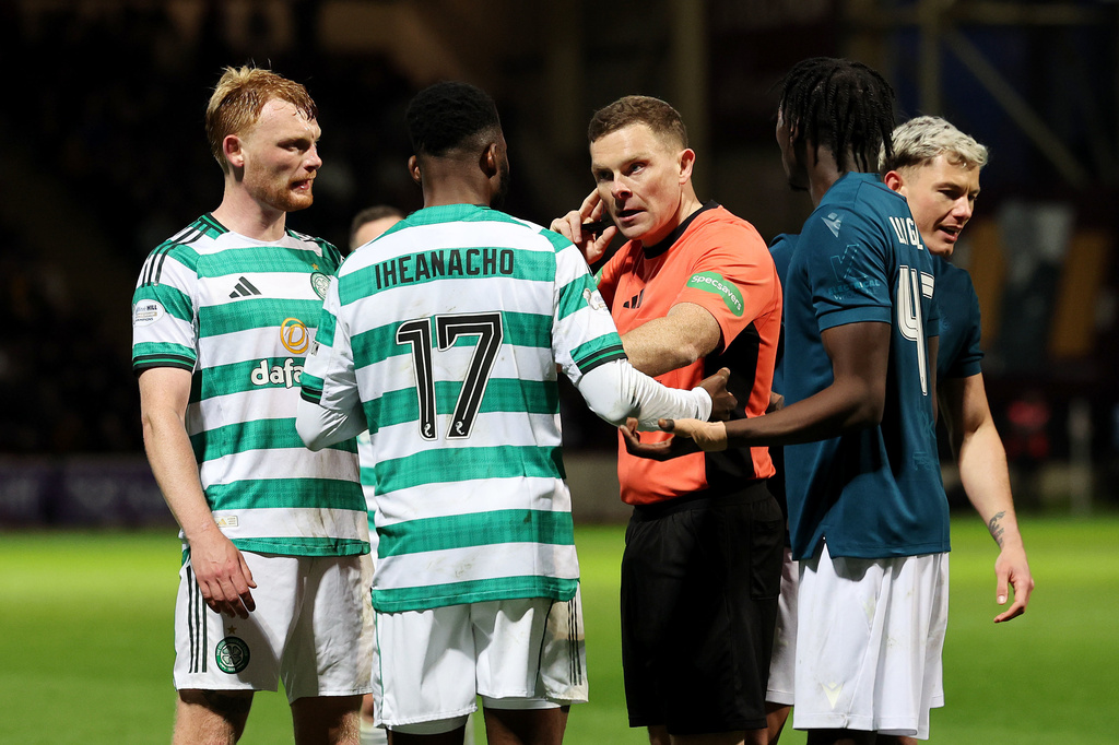 Referee John Beaton, center, speaks to Celtic's Kelechi Iheanacho before going to the VAR monitor and awarding a penalty to Celtic during the Scottish Premiership soccer match between Motherwell and Celtic, Wednesday May 13, 2026, in Motherwell, Scotland. (Robert Perry/PA via AP)