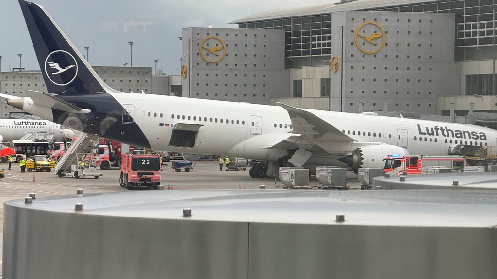 A Lufthansa 'Dreamliner' aircraft lies on its nose in front of a terminal at the Frankfurt Airport in Frankfurt, Germany, Thursday, June 4, 2026, after the nose landing gear collapsed. (Mike Seeboth/dpa via AP)