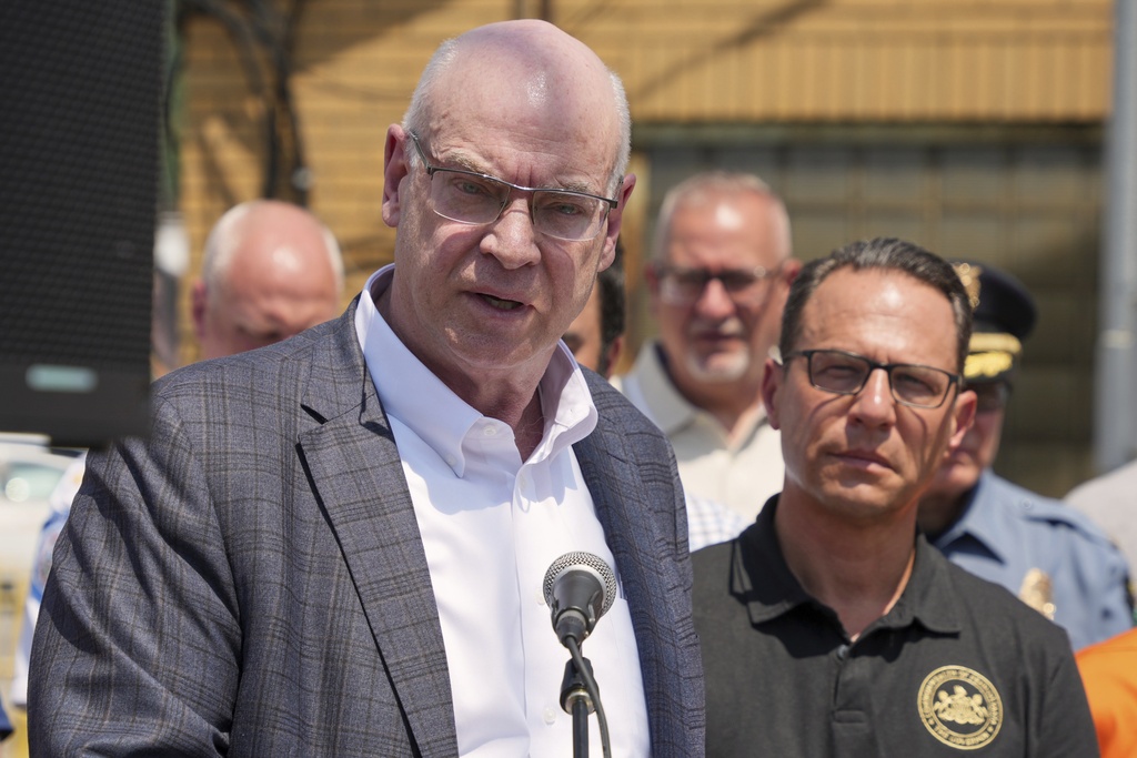 Pennsylvania Governor Josh Shapiro, right, listens as U.S. Steel President and CEO David B. Burritt answers a question during meeting with media at the Clairton Coke Works, a U.S. Steel plant, in Clairton, Pa., Tuesday, Aug. 12, 2025. (AP Photo/Gene J. Puskar)