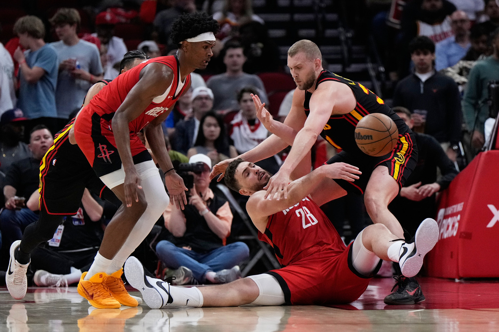 Houston Rockets center Alperen Sengun (28) passes against Atlanta Hawks center Jock Landale (31) during the first half of an NBA basketball game in Houston, Friday, March 20, 2026. (AP Photo/Ashley Landis)