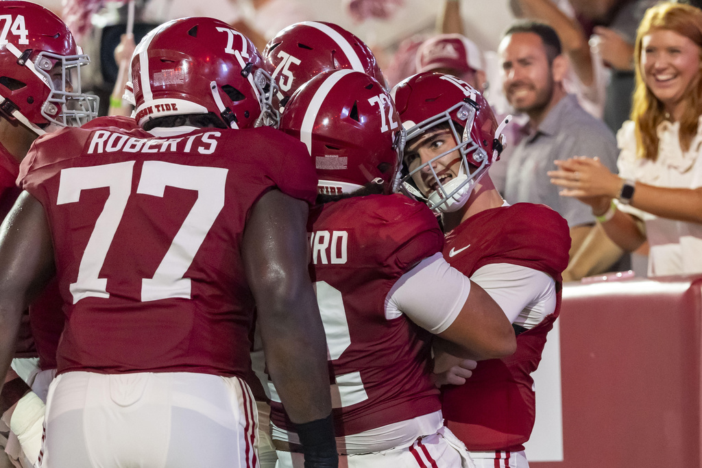 Alabama quarterback Ty Simpson (15) celebrates his running touchdown with his teammates during the first half of an NCAA college football game against Louisiana-Monroe, Saturday, Sept. 6, 2025, in Tuscaloosa, Ala. (AP Photo/Vasha Hunt)
