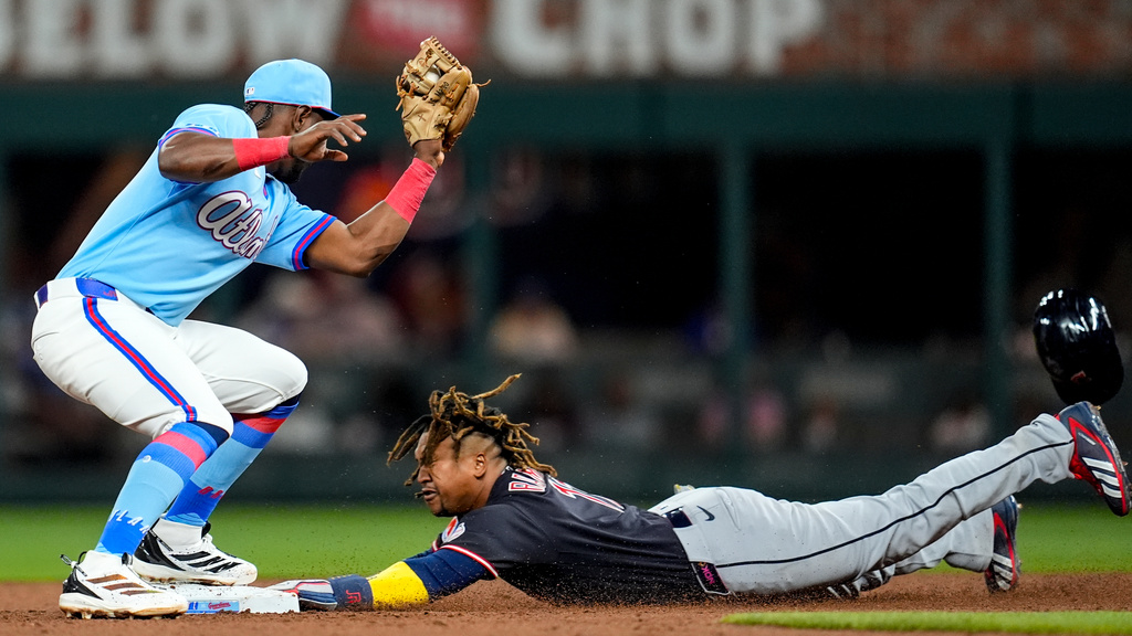 Cleveland Guardians' José Ramírez (11) steals second base from Atlanta Braves shortstop Jorge Mateo (2) in the sixth inning of a baseball game, Saturday, April 11, 2026, in Atlanta. (AP Photo/Mike Stewart)