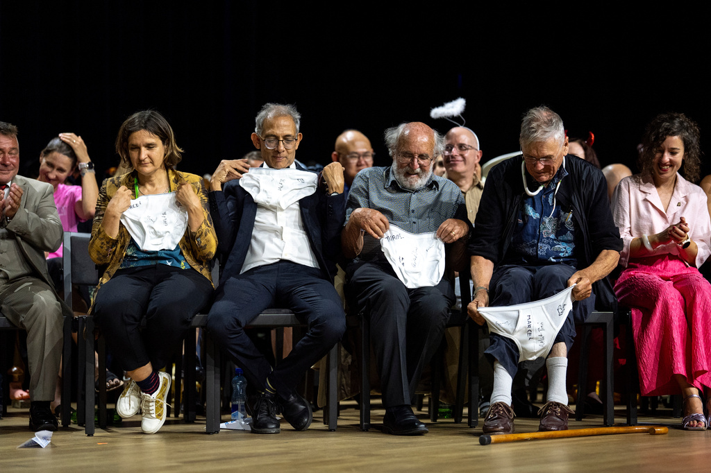 From left, Nobel Prize winners Esther Duflo, Abhijit Banerjee, Michel Mayor and Tim Hunt look at underwear handed over by the Soil Science Award Winners during the Ig Nobel Prize ceremony held in the Zurich Convention Center in Zurich, Switzerland, on Thursday, Sept. 3, 2026. (Claudio Thoma/Keystone via AP)