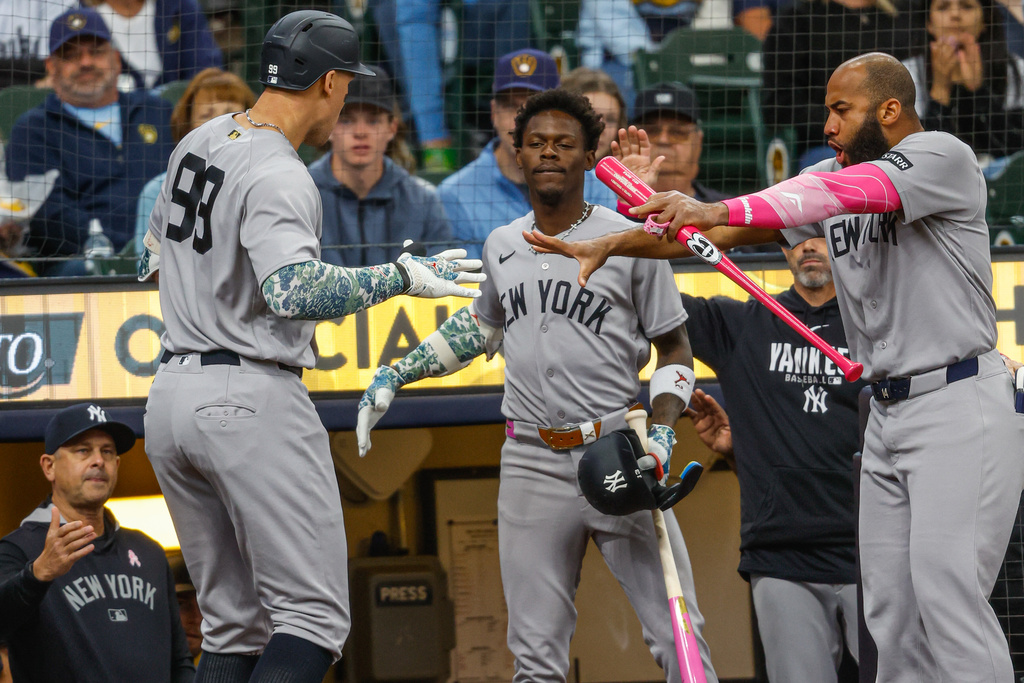 New York Yankees' Aaron Judge (99) reacts with Jazz Chisholm Jr., center, and Amed Rosario, right, after his home run during the first inning against the Milwaukee Brewers Sunday, May 10, 2026, in Milwaukee. (AP Photo/Jeffrey Phelps)