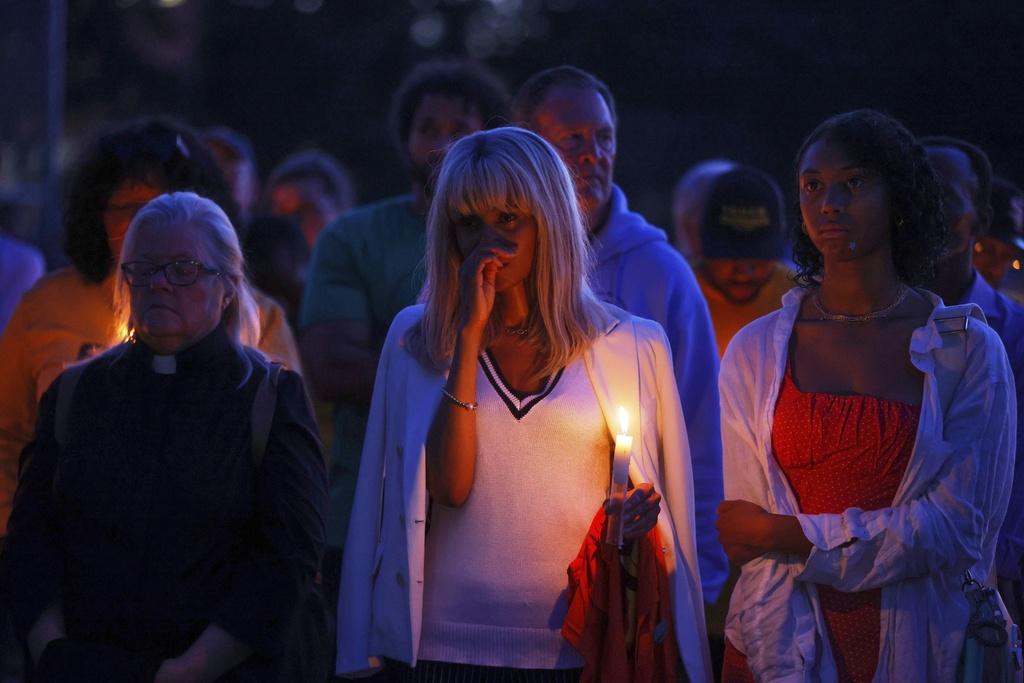 People gather at a vigil at Lynnhurst Park after a shooting at the Annunciation Catholic School Wednesday, Aug. 27, 2025, in Minneapolis. (AP Photo/Bruce Kluckhohn)
