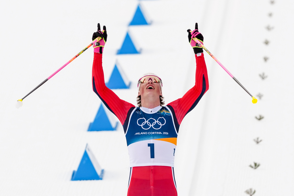 Johannes Hoesflot Klaebo, of Norway, crosses the finish line to win the gold medal during the cross country skiing men's 50km mass start Classic at the 2026 Winter Olympics, in Tesero, Italy, Saturday, Feb. 21, 2026. (AP Photo/Kirsty Wigglesworth)