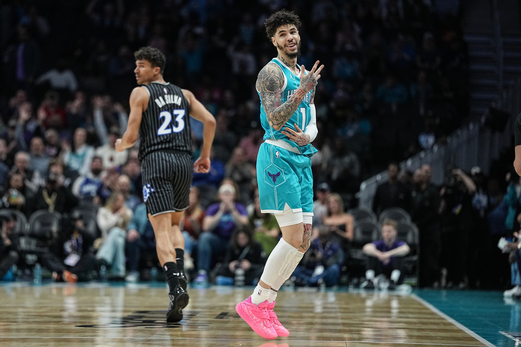 Charlotte Hornets guard LaMelo Ball (1) gestures after making a 3-point basket during the first half of an NBA basketball game against the Orlando Magic, Thursday, March 19, 2026, in Charlotte, N.C. (AP Photo/Matt Kelley)