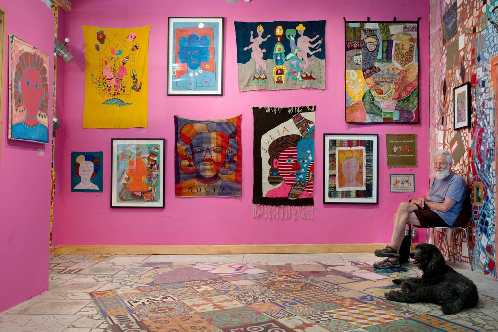 FILE - Isaiah Zagar sits with his dog Blue at the "Dear Julia" exhibit during an interview at Philadelphia's Magic Gardens, May 26, 2016. (AP Photo/Matt Rourke, File)