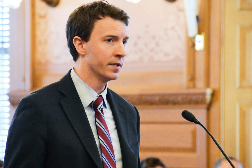 FILE - Bryan Seeley, a Major League Baseball senior vice president, testifies on a bill during a legislative committee hearing, March 13, 2018, at the Statehouse in Topeka, Kan. (AP Photo/Mitchell Willetts, File)