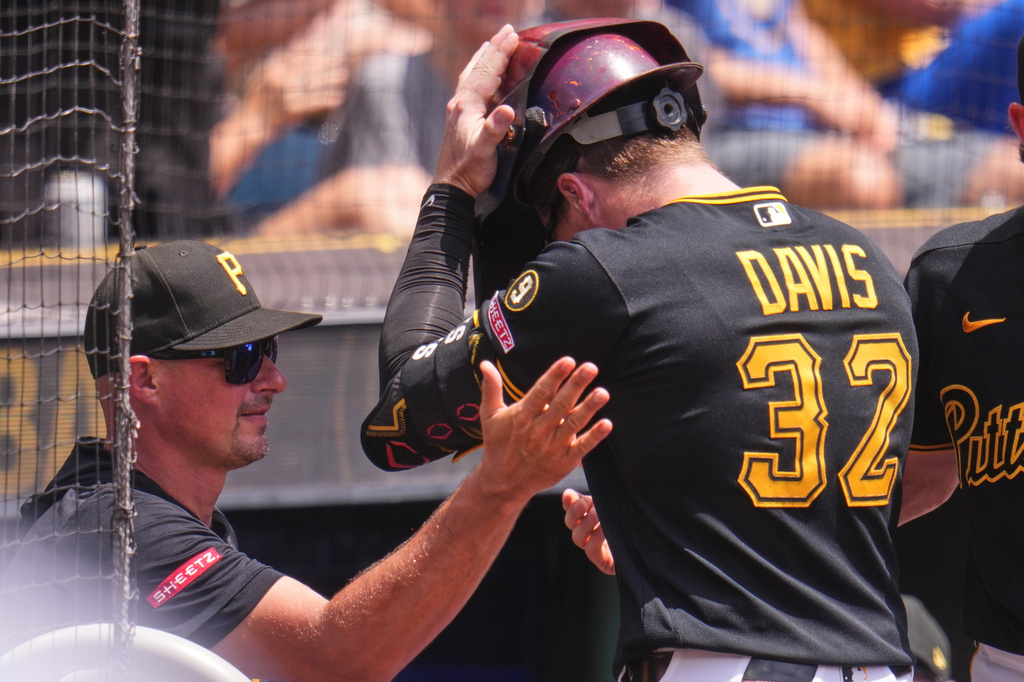 Pittsburgh Pirates' Henry Davis (32) is greeted at the dugout steps by manager Don Kelly, left, after hitting a two-run home run off Milwaukee Brewers pitcher Robert Gasser during the second inning of a baseball game in Pittsburgh, Sunday, July 12, 2026. (AP Photo/Gene J. Puskar)
